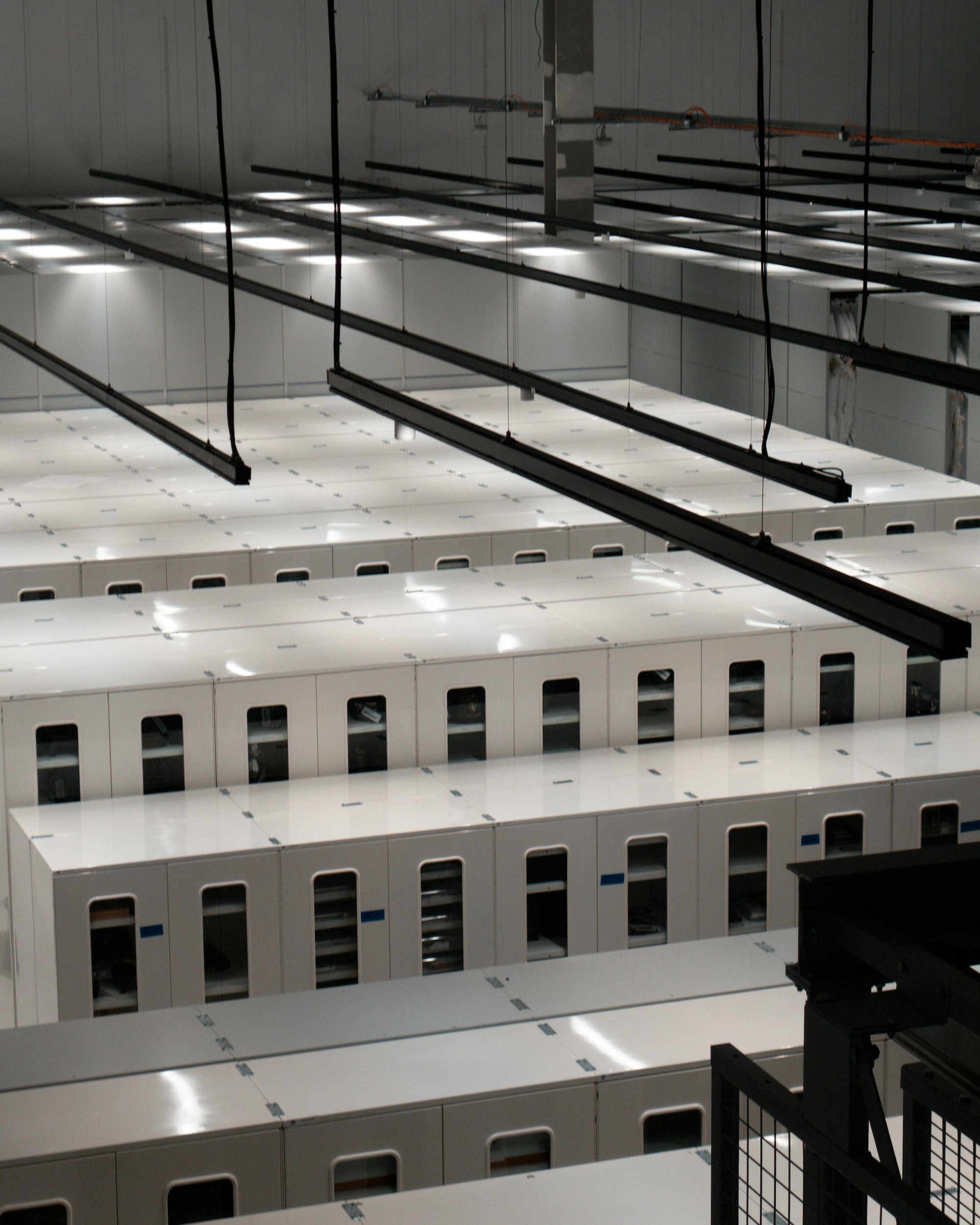 Modern data centre with rows of white server cabinets